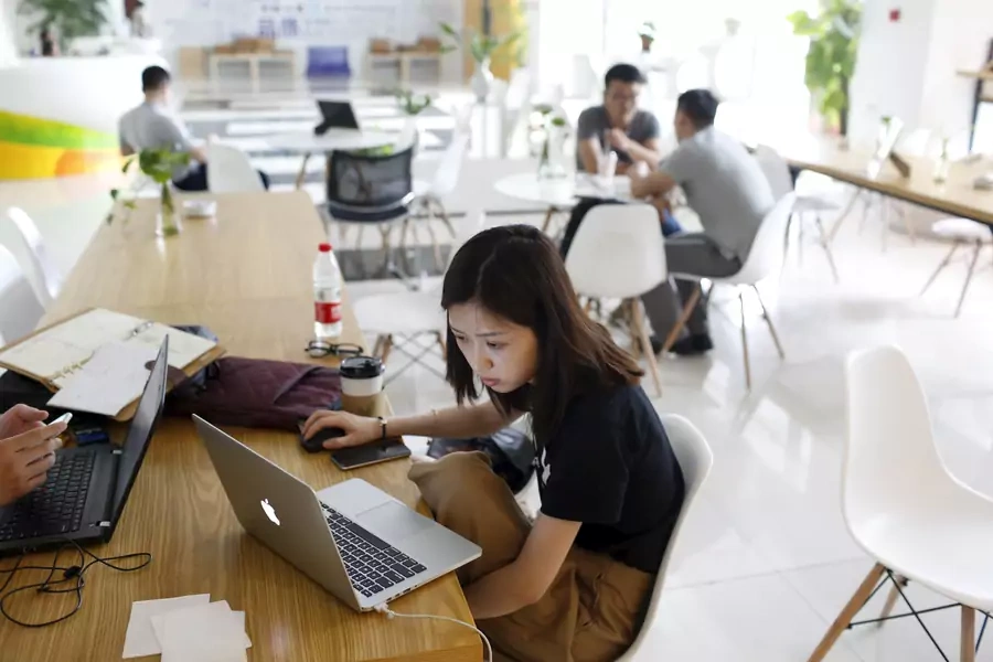 Young entrepreneurs look at their computers at a resting area inside the University Students Venture Park, in Shanghai, China, July 29, 2015. The University Students Venture Park in northern Shanghai was designed as an incubator for college students.