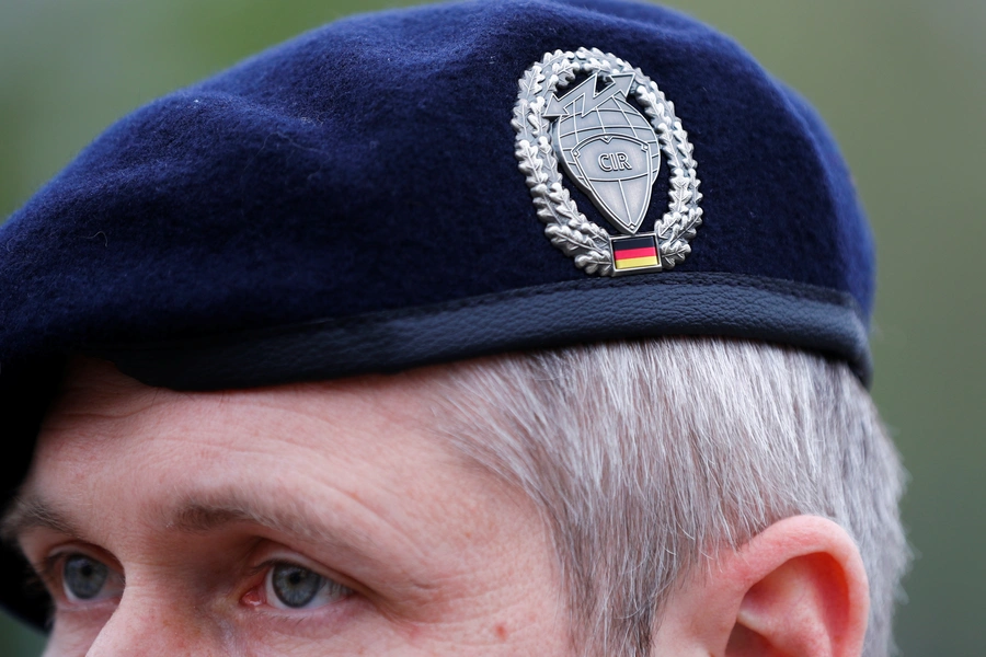 The badge of Germany's cyber and information space command on the cap of a soldier.