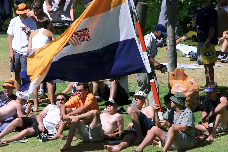 South African cricket fans with an apartheid era flag watch the last day of the first test match against New Zealand in South Africa, November 21, 2000. This flag was reportedly flown at recent Black Monday protests in South Africa.