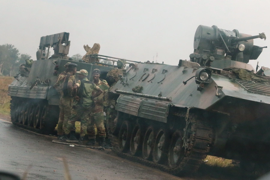 Soldiers stand beside military vehicles just outside Harare, Zimbabwe's capital, November 14, 2017.