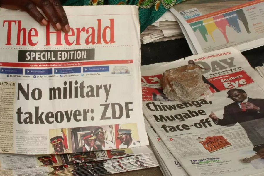 A vendor picks up a copy of a special edition of the state-owned daily newspaper The Herald in Harare, Zimbabwe November 15, 2017. The military has repeatedly stressed that no coup has taken place.