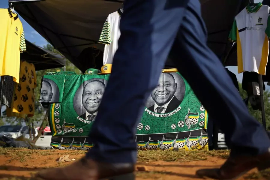 A man walks past ANC merchandise with the face of newly elected president Cyril Ramaphosa outside the venue of the 54th National Conference of the ruling African National Congress (ANC) at the Nasrec Expo Centre in Johannesburg, South Africa.