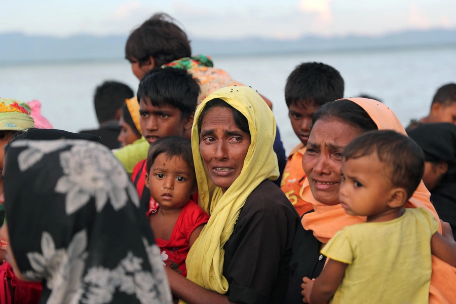 Rohingya refugee women cry while crossing the Naf River with an improvised raft to reach to Bangladesh in Teknaf, Bangladesh, November 12, 2017.