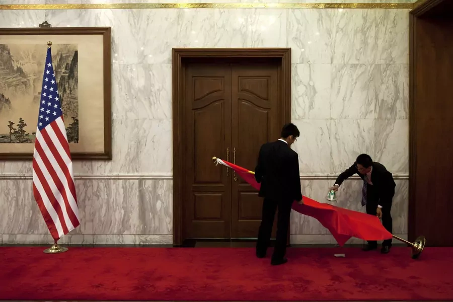 Chinese officials prepare the Chinese flag before a meeting with U.S. officials in 2013.