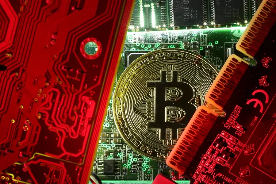 A coin representing the bitcoin cryptocurrency is seen on computer circuit boards in this illustration picture, October 26, 2017.