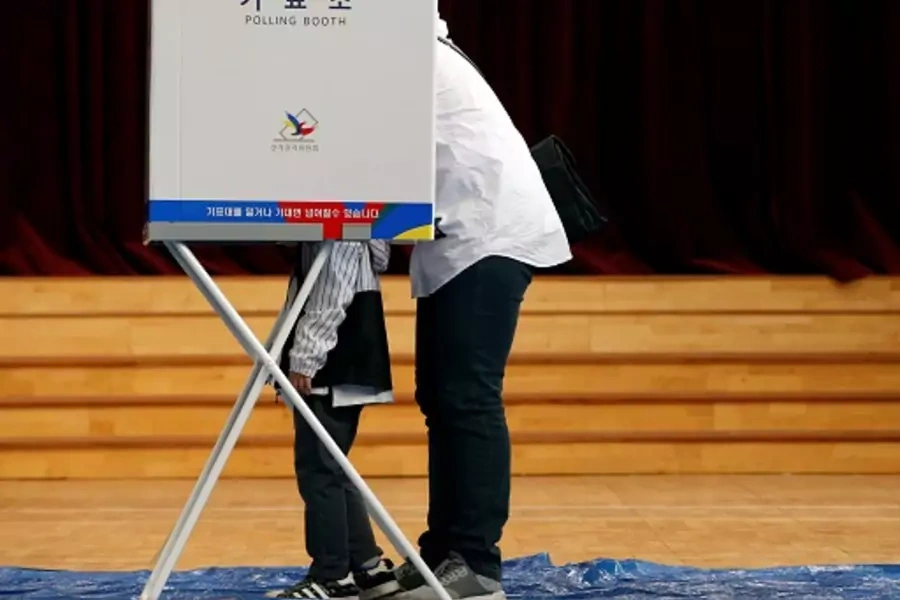 A parent and child in the voting booth during South Korea’s 2017 presidential election. 