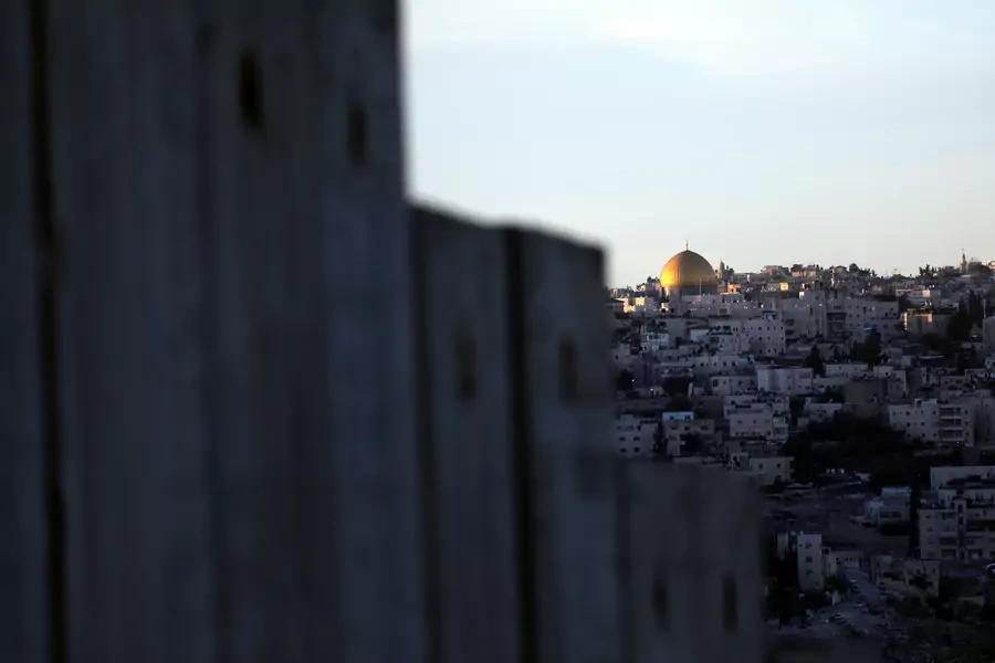 The Dome of the Rock and Jerusalem's Old City can be seen over the Israeli barrier from the Palestinian town of Abu Dis in the West Bank (Ammar Awad/Reuters).