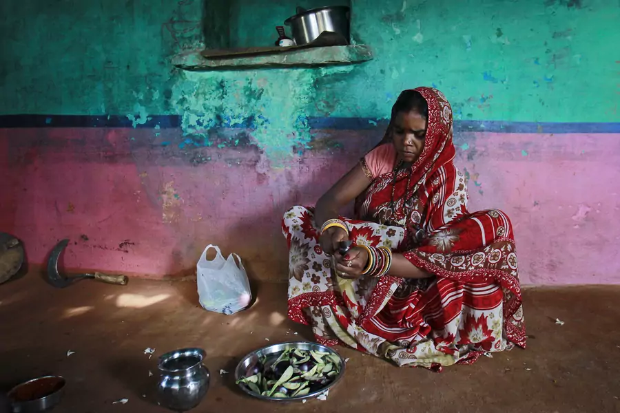Krishna, 13, cuts vegetables inside the kitchen at her house in a village near Baran, located in the northwestern state of Rajasthan, July 17, 2012. Krishna married her husband Gopal when she was 11 and he was 13.