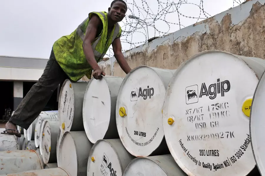 A man arranges Agip drums at an oil station and depot in Nigeria's capital Abuja, June 19, 2009. 