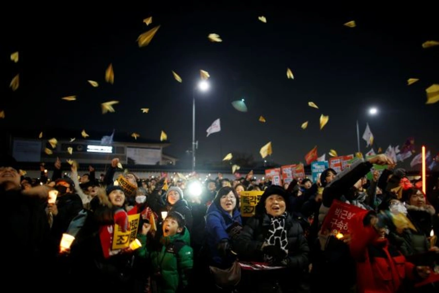 People fly paper airplanes as they march toward the Presidential Blue House during a protest demanding South Korean President Park Geun-hye's resignation in Seoul, South Korea, January 7, 2017.