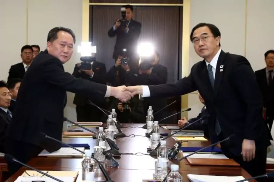 Head of the North Korean delegation, Ri Son Gwon shakes hands with South Korean counterpart Cho Myoung-gyon as they exchange documents after their meeting at the truce village of Panmunjom in the demilitarised zone separating the two Koreas.