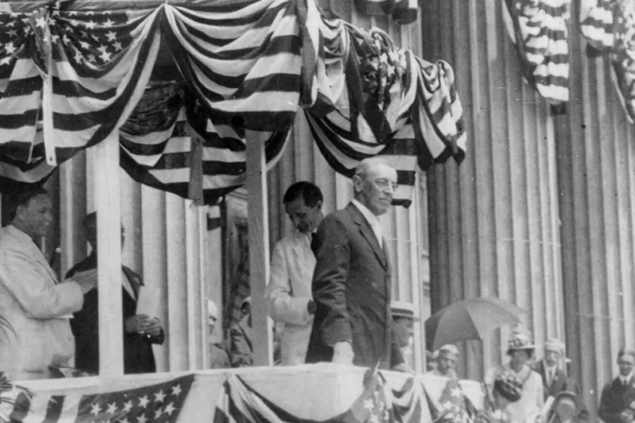 Woodrow Wilson standing on a flag-bedecked podium on Flag Day, May 1915. 
