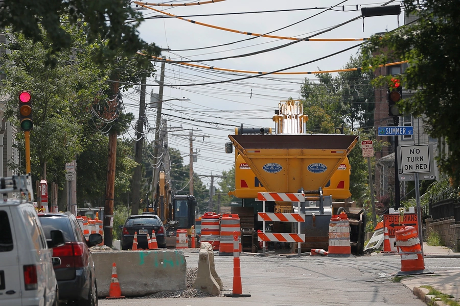 Construction equipment fills a portion of Cedar Street during a years-long water main and sewer renovation project under the street in Somerville, Massachusetts, U.S.