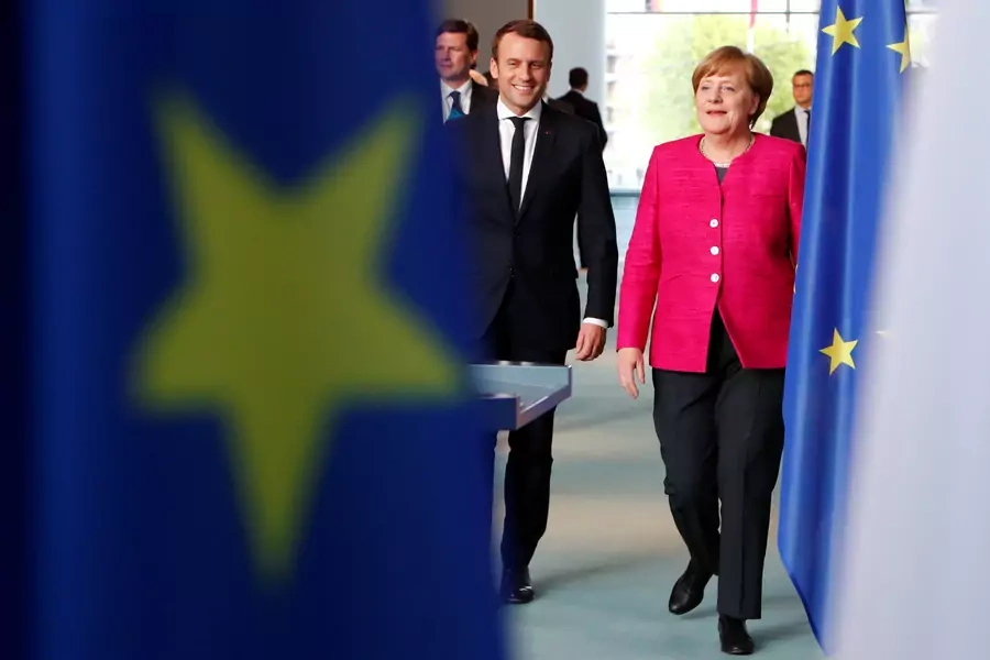 German Chancellor Angela Merkel and French President Emmanuel Macron arrive to a news conference at the Chancellery in Berlin on May 15, 2017. 