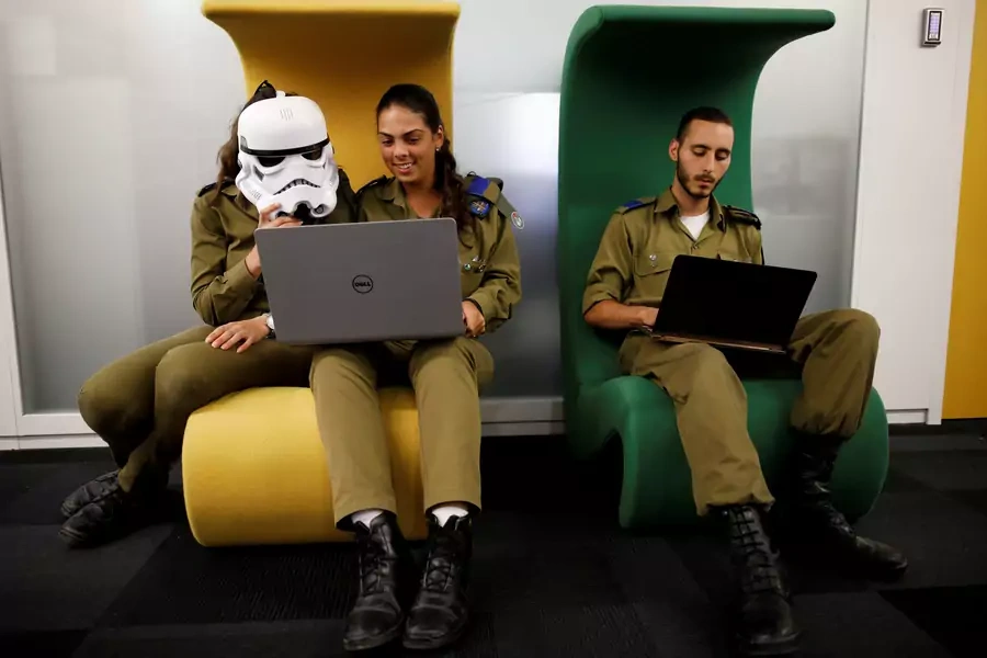 Israeli soldiers work on laptops as they take part in a cyber security training course in August 2017. 