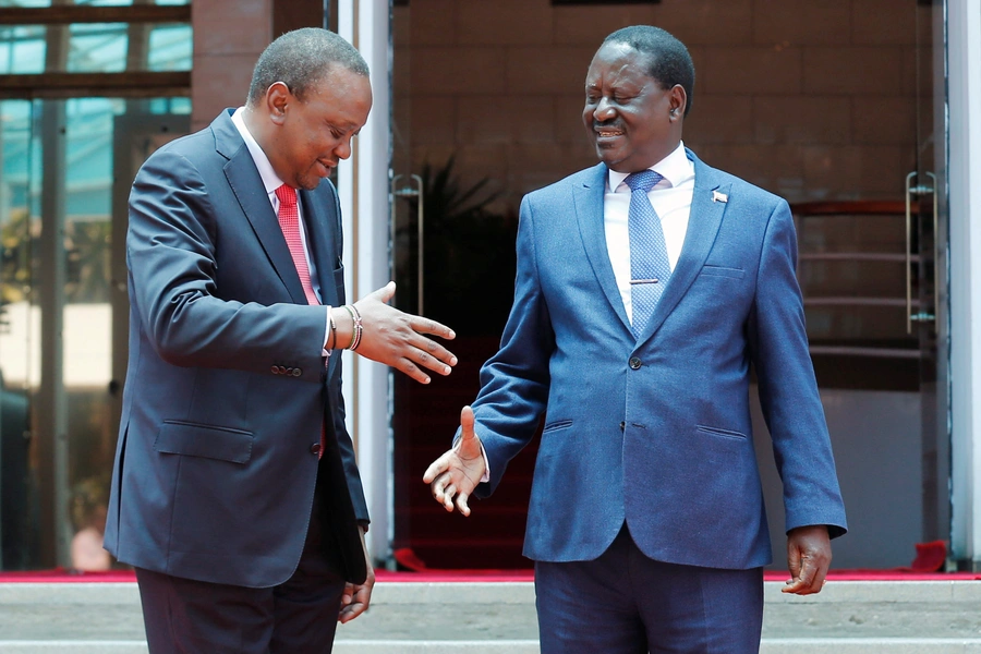 Kenya's President Uhuru Kenyatta (L) greets opposition leader Raila Odinga of the National Super Alliance (NASA) coalition after addressing a news conference at the Harambee house office in Nairobi, Kenya March 9, 2018.