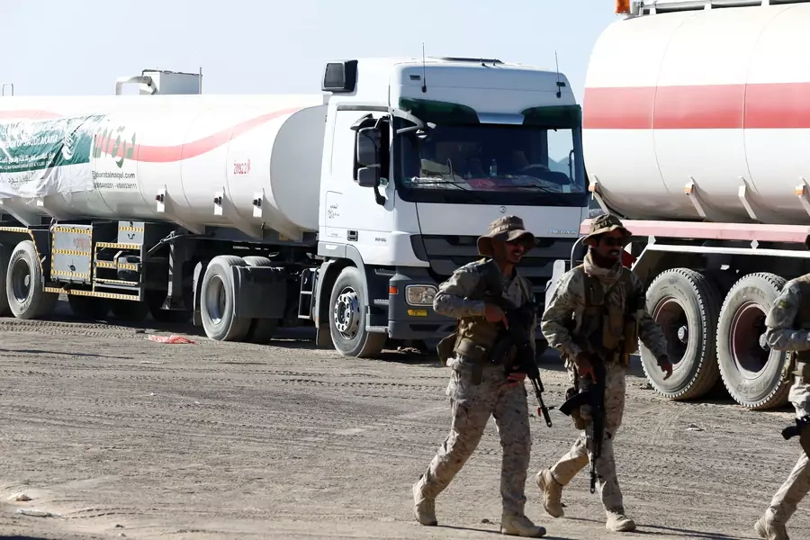 Saudi soldiers walk by oil tanker trucks delivered by Saudi authorities to support charities and NGOs in Marib, Yemen January 26, 2018. Picture taken January 26, 2018. 