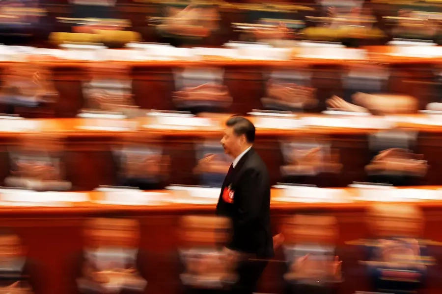 Chinese President Xi Jinping walks to deliver his speech at the closing session of the National People's Congress at the Great Hall of the People in Beijing on March 20, 2018.