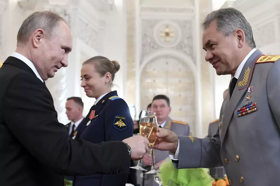Russian President Vladimir Putin toasts with Defence Minister Sergei Shoigu after a state awards ceremony for military personnel who served in Syria, at the Kremlin in December 2017. 