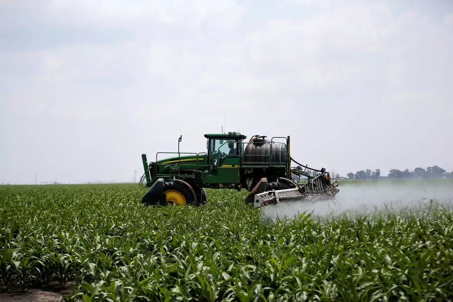 A worker uses a tractor to spray a field of crops during crop-eating armyworm invasion at a farm in Settlers, South Africa, February 8, 2017. Central to land reform is its effect on food security, which Ramaphosa has promised to maintain.