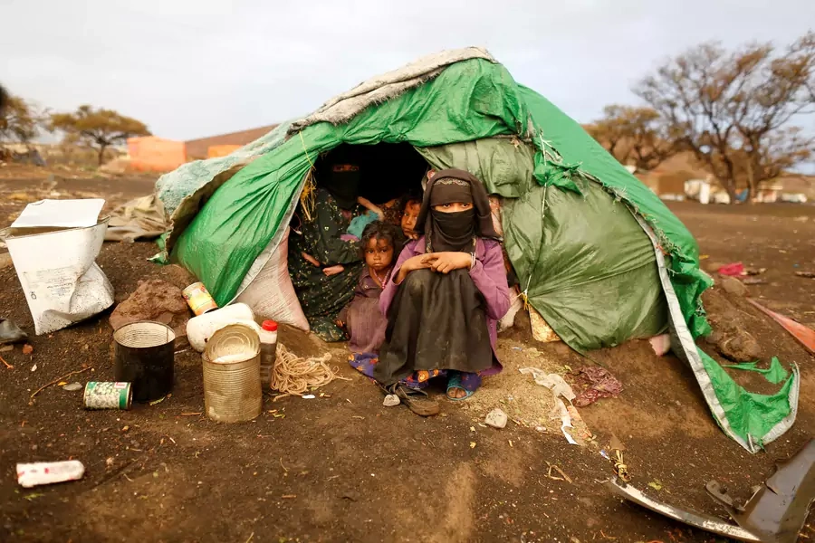 A woman and girls sit in their tent at a camp for internally displaced people (IDPs) near Sanaa, Yemen March 17, 2018. 