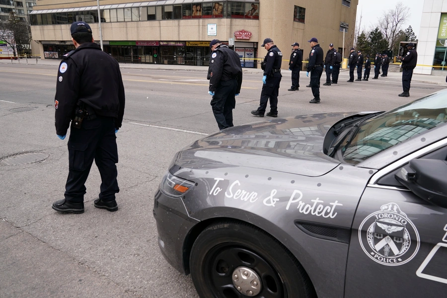 Police officers comb a street for evidence after a van struck multiple people along a major intersection in north Toronto, Ontario, Canada, April 24, 2018. 