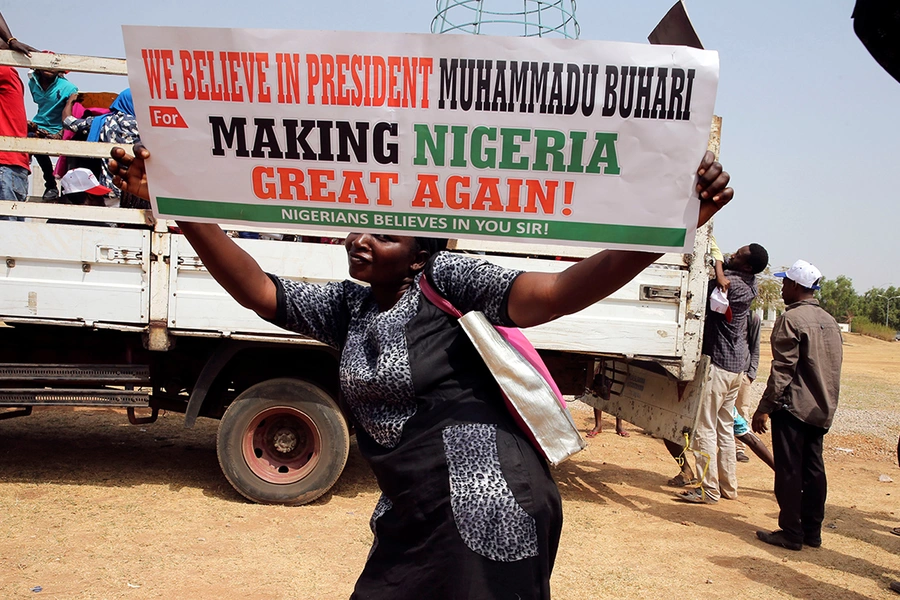 A woman holds a placard during a rally in Abuja, Nigeria, to show support for President Muhammadu Buhari. 