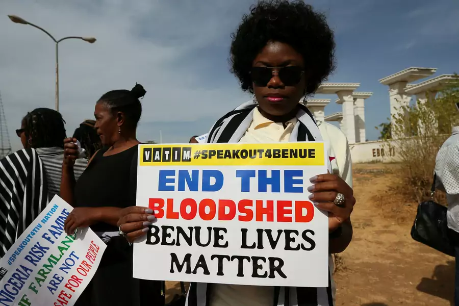 A protestor holds a placard during a demonstration against Fulani herdsmen killings, in Abuja, Nigeria March 16, 2017.