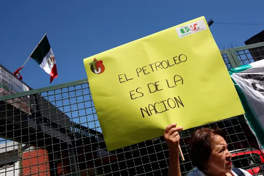 A union worker holds a placard as she protests outside Pemex headquarters to demand better contracts for technicians and other professionals, in Mexico City, Mexico November 7, 2017. The placard reads: "The oil is from the nation."