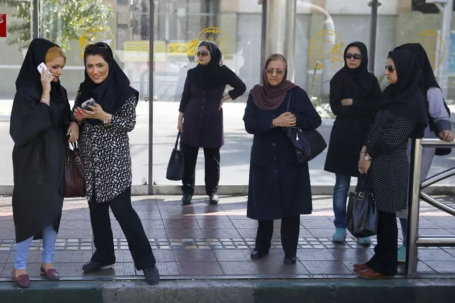 Women wait for a bus in central Tehran, Iran.