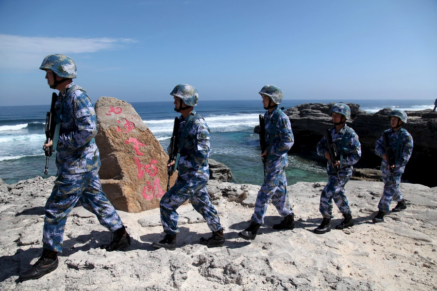 Soldiers of China's People's Liberation Army (PLA) Navy patrol at Woody Island, in the Paracel Archipelago, which is known in China as the Xisha Islands. January 29, 2016.