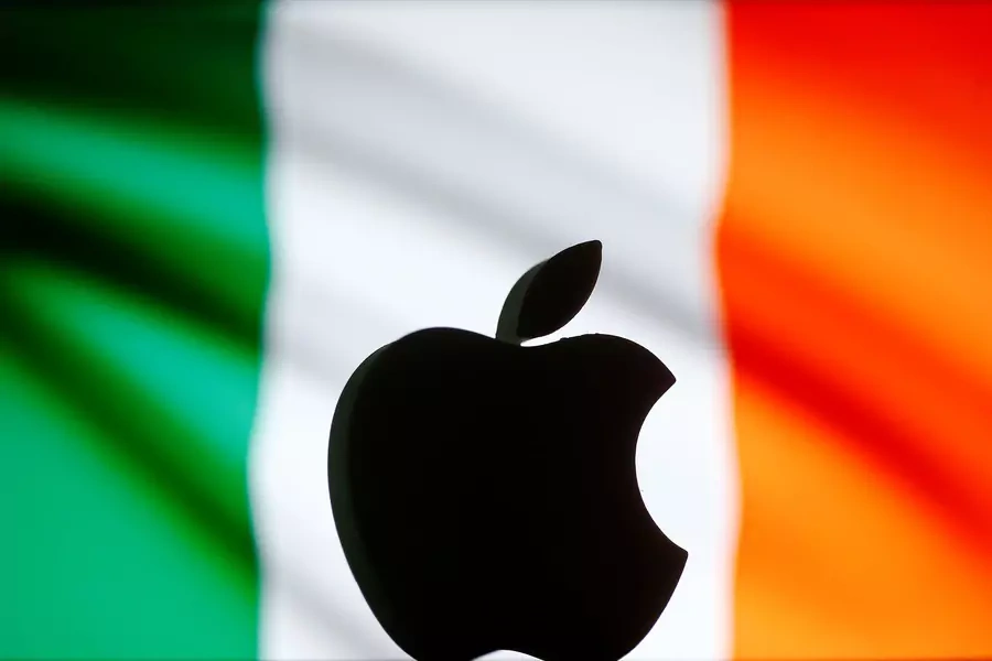A 3D printed Apple logo in front of an Irish flag.