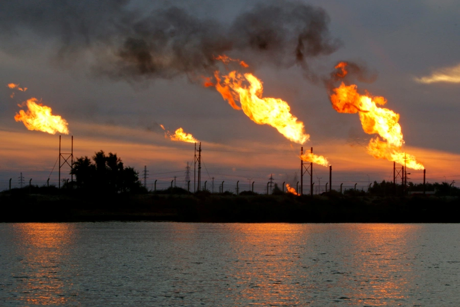 Flames emerge from flare stacks at the oil fields in Basra, southeast of Baghdad, Iraq January 17, 2017.