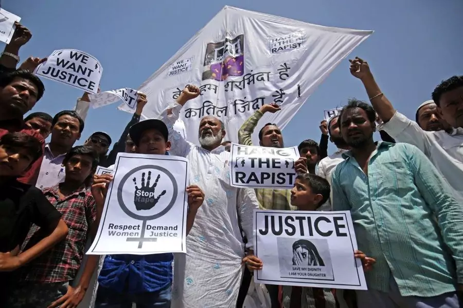 People hold placards at a protest against the rape of an eight-year-old girl in Kathua, in Ahmedabad, India.