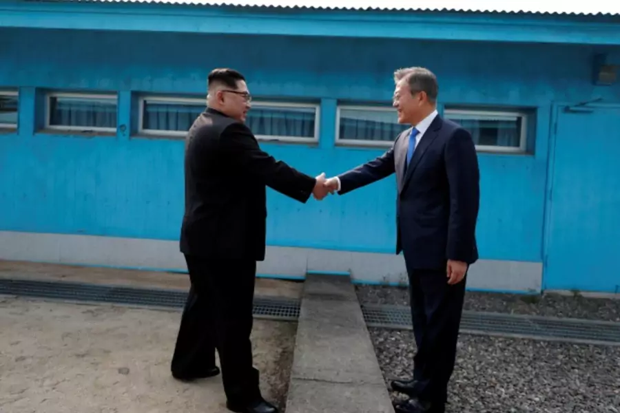 South Korean President Moon Jae-in shakes hands with North Korean leader Kim Jong Un during their meeting at the truce village of Panmunjom inside the demilitarized zone separating the two Koreas, South Korea, April 27, 2018.