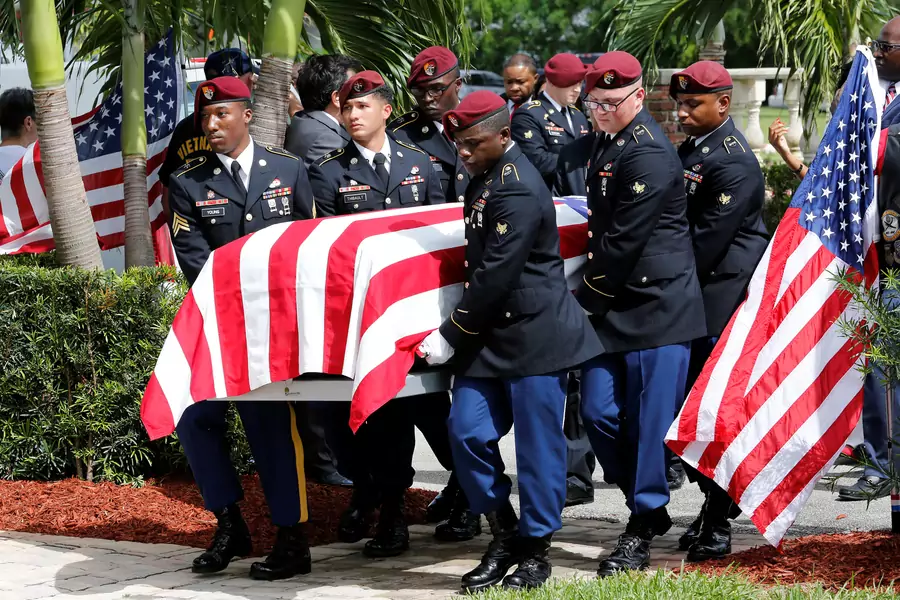 An honor guard carries the coffin of U.S. Army Sergeant La David Johnson, who was among four special forces soldiers killed in Niger, at a graveside service in Hollywood, Florida, October 21, 2017.