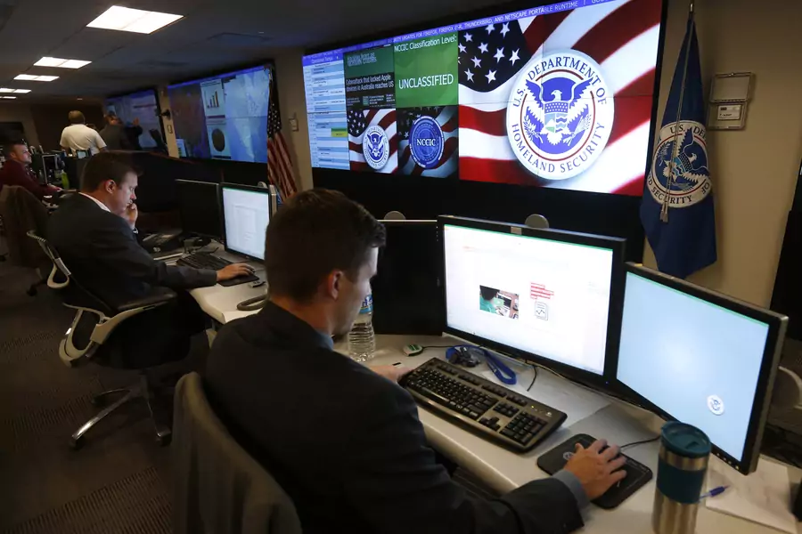 U.S. Department of Homeland Security employees work during a guided media tour inside the National Cybersecurity and Communications Integration Center in Arlington, Virginia on June 26, 2014