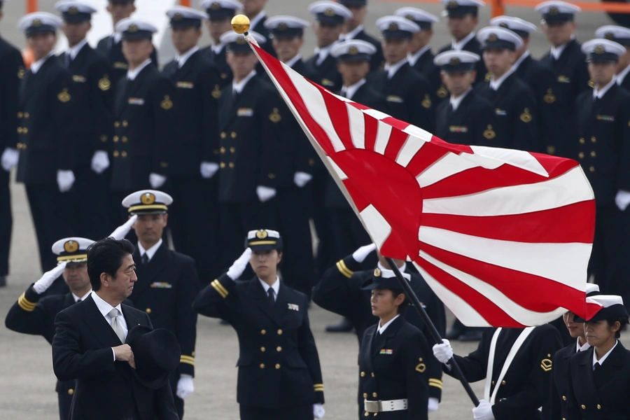 Japan's Prime Minister Shinzo Abe (L) reviews members of Japan Self-Defense Force (JSDF) during the JSDF Air Review, to celebrate 60 years since the service's founding at Hyakuri air base in Omitama on October 26, 2014.