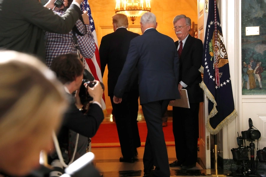 White House National Security Advisor John Bolton (R) departs with U.S. President Donald Trump and Vice President Mike Pence after Trump announced his intention to withdraw from the Iran nuclear agreement on May 8, 2018.