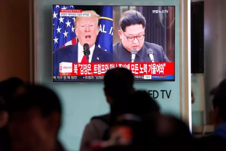 People watch a TV broadcasting a news report on a cancelled summit between the U.S. and North Korea, in Seoul, South Korea, May 25, 2018.