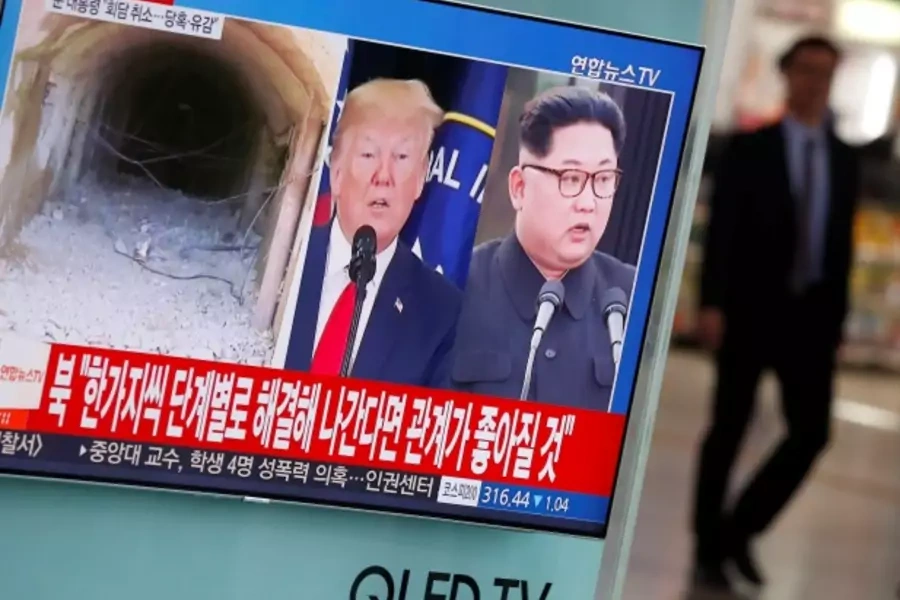 A man walks past a TV broadcasting a news report on a cancelled summit between the U.S. and North Korea, in Seoul, May 25, 2018.