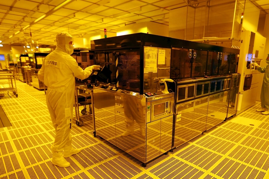 An employee is pictured inside a clean room of German semiconductor manufacturer Infineon in Regensburg on February 12, 2013.