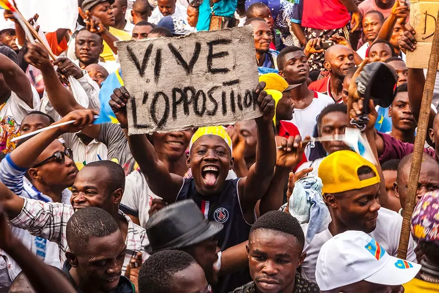An opposition supporter holds up a reading 'Long live the opposition' during a rally organised by political opposition parties in Kinshasa on July 31, 2016.