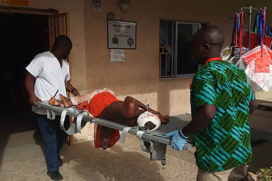 Paramedics carry a stretcher with a victim of a blast on it at the hospital in Maiduguri on June 17, 2018.