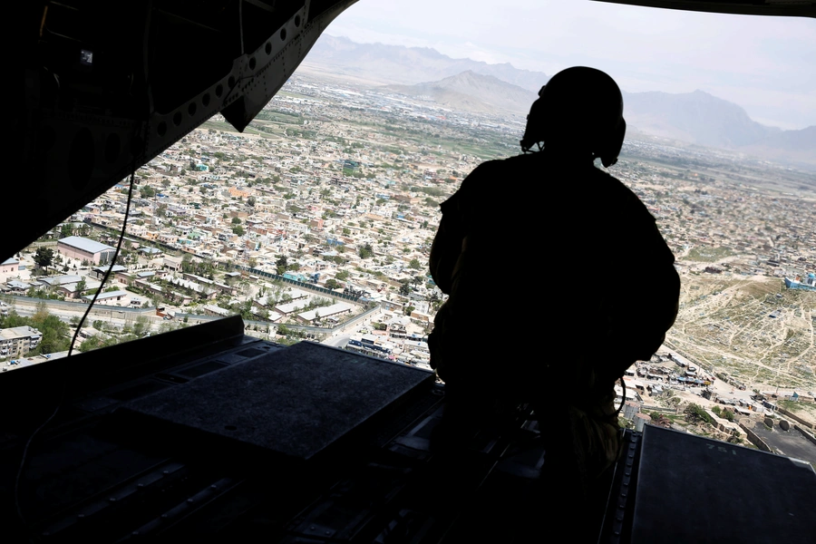 A U.S. soldier mans a gun at the back gate aboard the helicopter carrying U.S. Defense Secretary James Mattis as he arrives via helicopter at Resolute Support headquarters in Kabul, Afghanistan, on April 24, 2017.