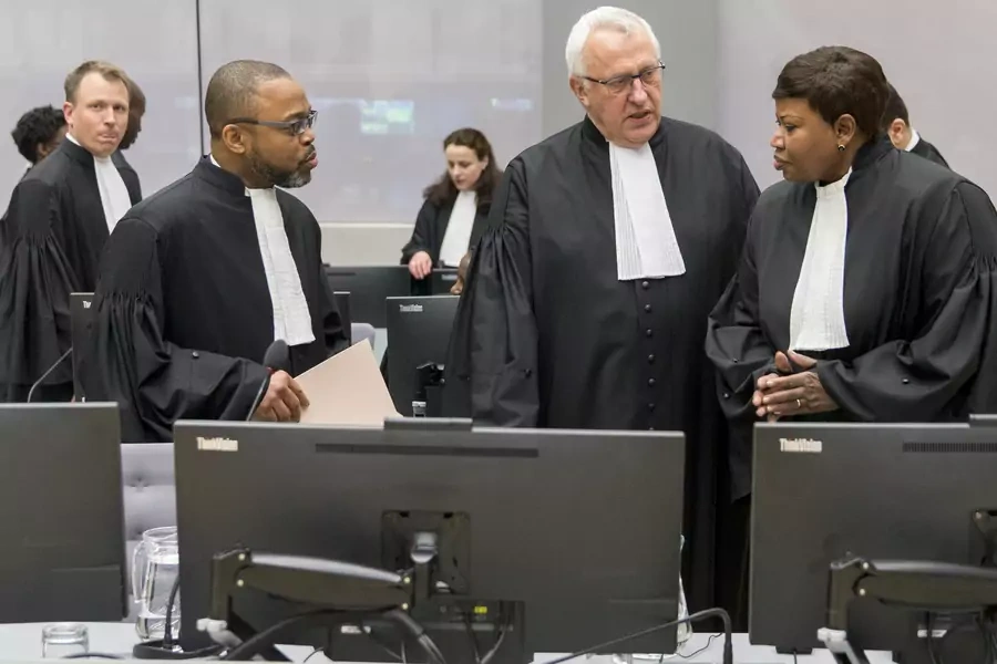 Jean-Jacques Badibanga,  James Stewart, and Chief Prosecutor Fatou Bensouda are seen in a court room of the ICC before the delivery of the judgment in the case of Jean-Pierre Bemba in the Hague, 2016.