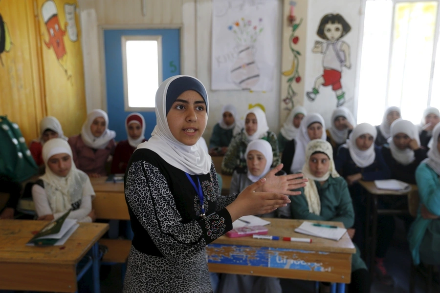Omayma al Hushan, 14, who launched an initiative against child marriage among Syrian refugees, speaks at a school in Al Zaatari refugee camp.