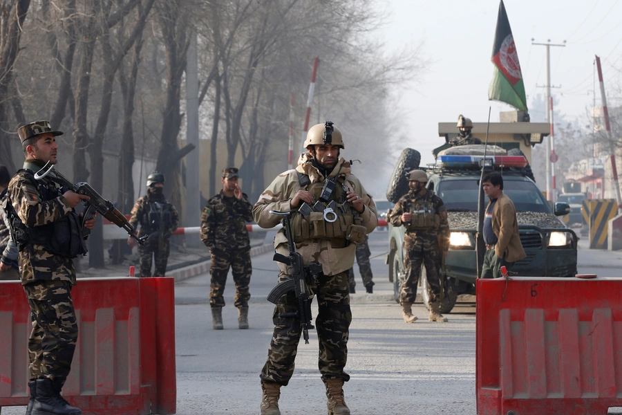 Afghan security forces keep watch at a check point close to a compound of Afghanistan's national intelligence agency in Kabul, Afghanistan. December 25, 2017.