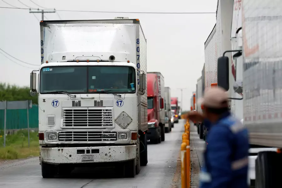 Trucks wait in the queue for border customs control to cross into U.S. at the World Trade Bridge in Nuevo Laredo, Mexico April 5, 2018. 