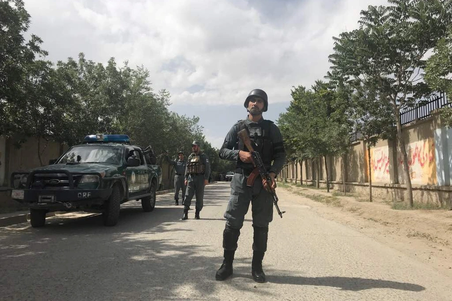 An Afghan policeman keeps watch near the site of a suicide attack in Kabul, Afghanistan.